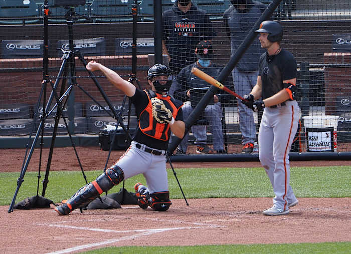 SF Giants catcher Patrick Bailey throws a ball back to the pitcher while Austin Slater bats at the alternate site. (2020)